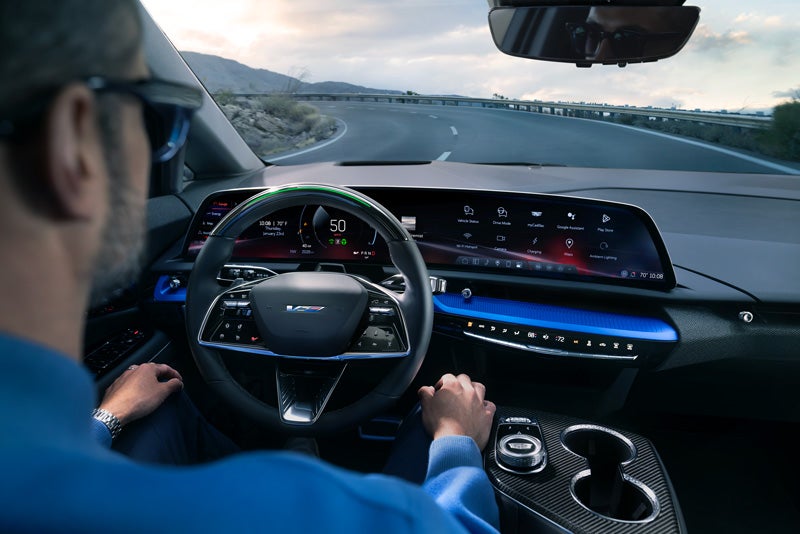 Front View of the 2026 OPTIQ-V Driving Through the Dusk Utilizing its Headlights | Dan Vaden Chevrolet Brunswick in Brunswick GA